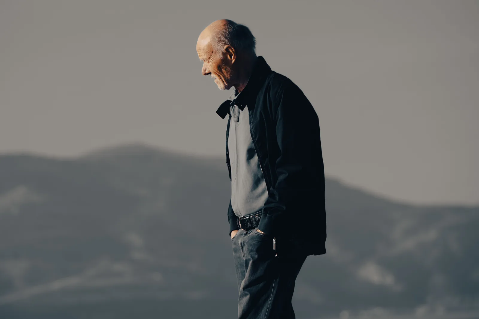 Older man taking a relaxed daytime walk outdoors