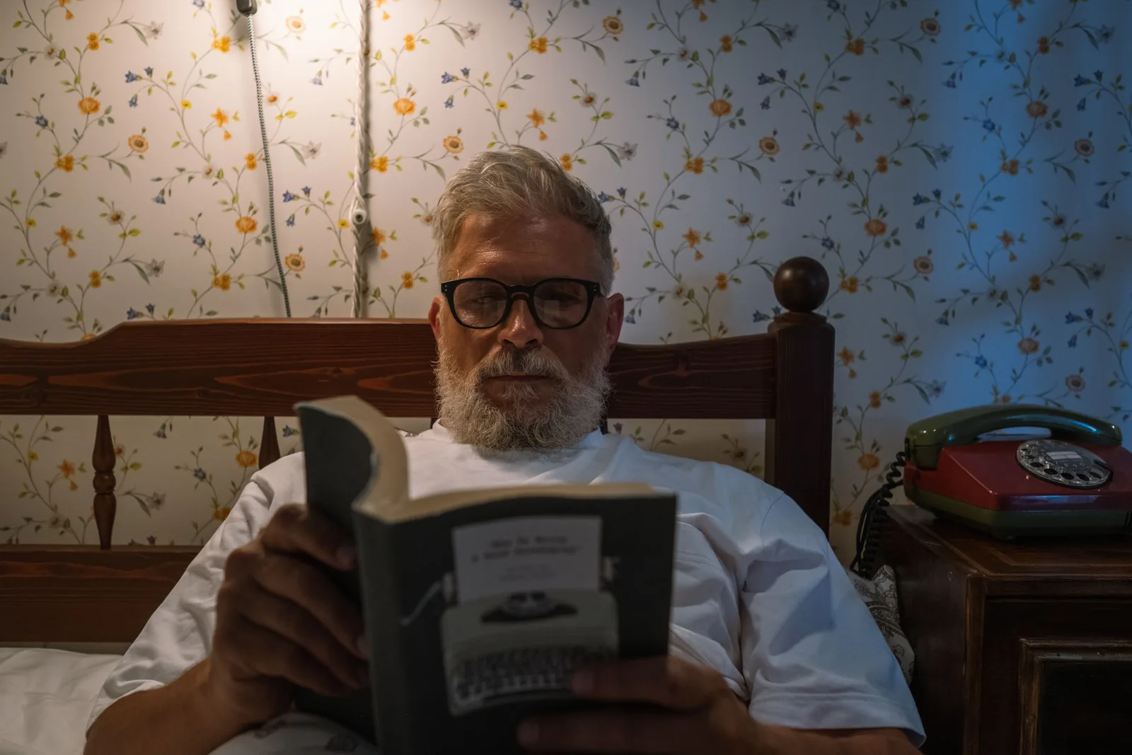 Older man reading in a quiet evening setting